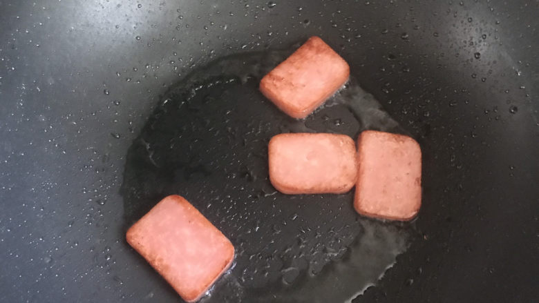 耳光炒饭,起锅热油,下入午餐肉小火煎至表面焦黄盛出备用