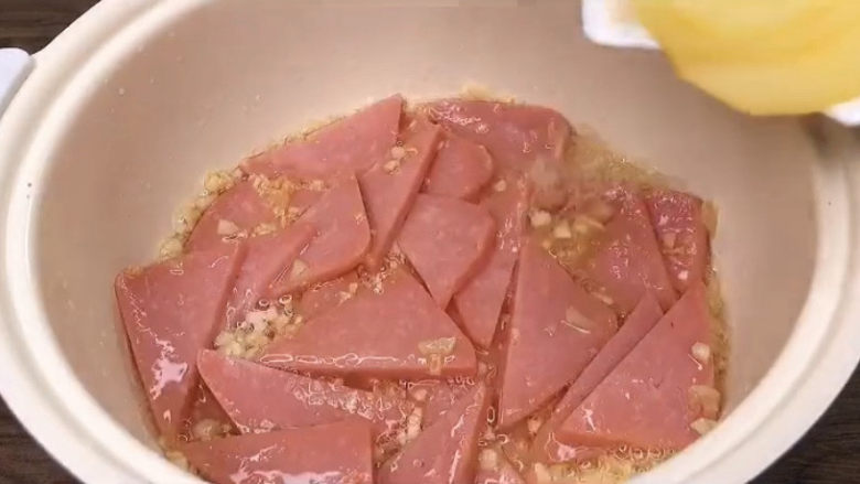青椒土豆片,先把火腿肠翻炒一会,微微变色,出香味了就可以了