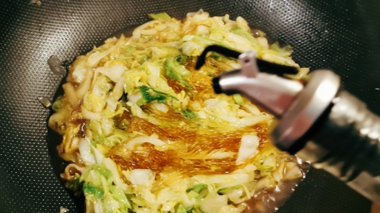 包菜炒粉丝,粉丝吸收了汤汁,倒入<a style='color:red;display:inline-block;' href='/shicai/ 3738'>芝麻油</a>增香。