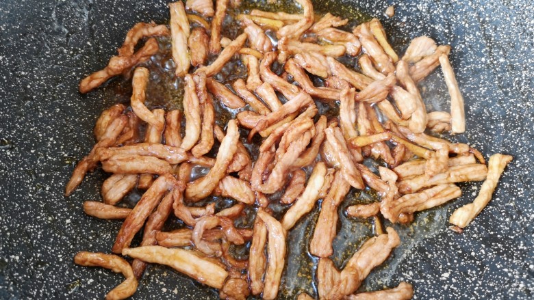 土豆炒肉丝,炒锅内倒适量的食用油烧热,下入腌好的肉丝炒熟,盛出备用。