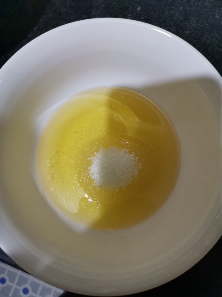 花生一口酥,花生油里加入白砂糖,拌匀