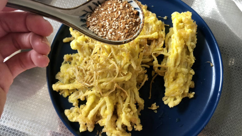 孜然金针菇,炸好的金针菇,装盘,均匀撒上调味料