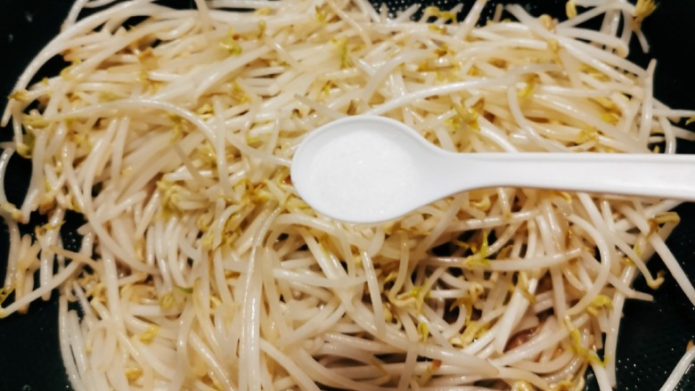 爆炒绿豆芽,放入盐调味,快速翻炒均匀。