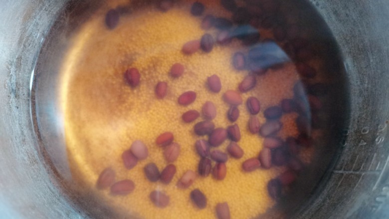 红豆小米粥,煮至膨胀,有一点点裂开的时候,把小米倒下去,继续煮