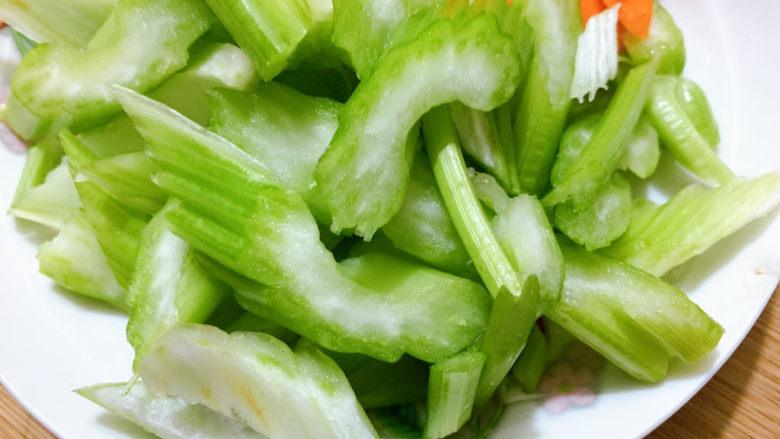 西芹炒鱿鱼,然后将西芹胡萝卜,先行入沸水中汆烫。