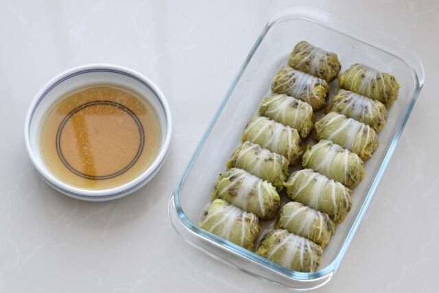 白菜包肉,将蒸好的白菜卷取出来,盘中会有汤汁,倒入小碗中留用。