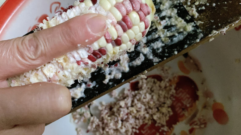 玉米粑粑,将生的糯玉米,手动磨成颗粒渣渣。