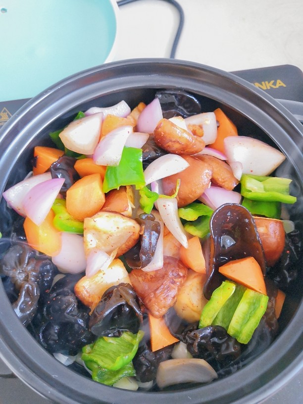 三汁焖锅,放入拌匀的蔬菜,翻炒。
