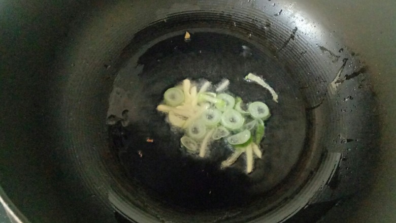 青椒炒千张,炒锅中加入适量花生油,油热放入葱花、姜丝煸炒出香味