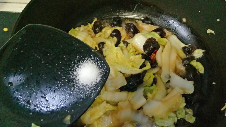 白菜炒木耳,盖上锅盖焖煮3分钟,根据自己口味加入适量油调味,翻炒均匀即可