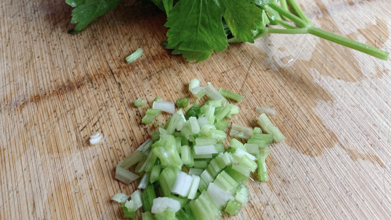 芹菜叶炒鸡蛋,芹菜的根茎跟叶子分离，根茎切成芹菜丁，叶子切成两段备用。