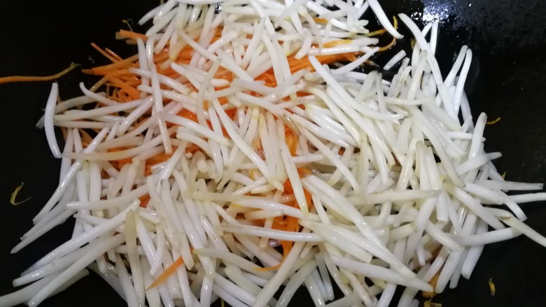 炒合菜,放入豆芽,改旺火急炒,炒掉豆芽的一些水气。