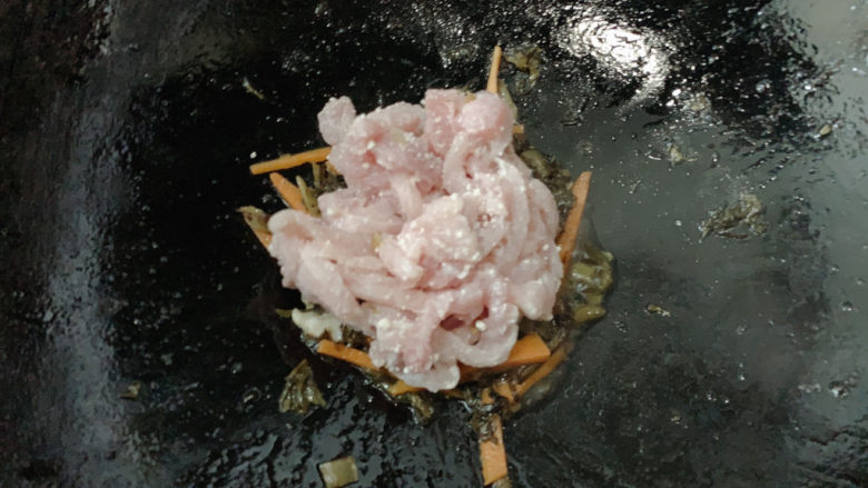雪菜炒肉丝,加入猪肉丝,中火快炒至猪肉变色