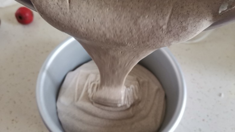 粗粮黑米蒸糕(少油少糖),倒入模具里,震几下震出气泡