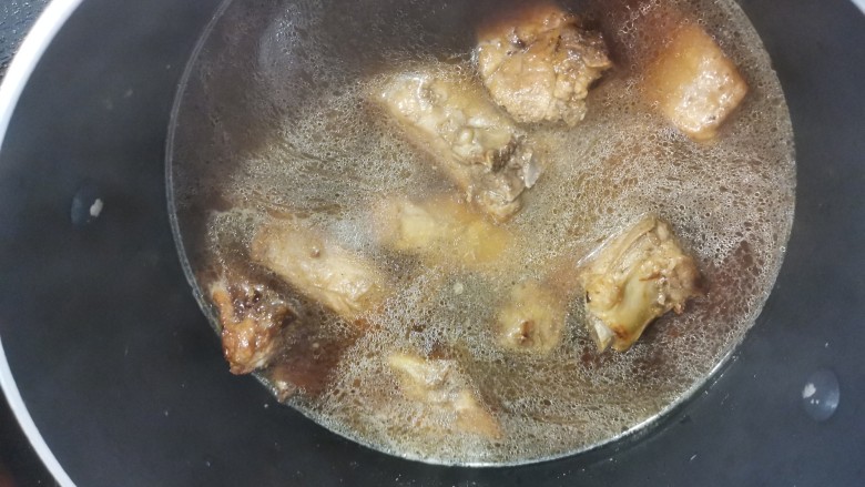排骨糯米饭,换一个汤锅继续煮,加入盐煮到排骨接近熟的状态。