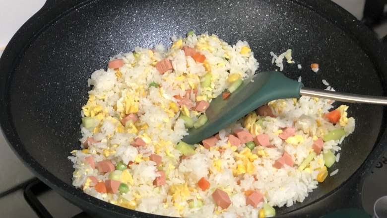 花环炒饭,下入解冻好的什锦蔬菜里翻炒;
