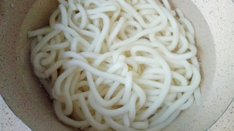 鸡蛋炒乌冬面,锅中加入适量清水煮开,放入<a style='color:red;display:inline-block;' href='/shicai/ 546'>乌冬面</a>煮2分钟,捞出过凉水,沥干水份备用