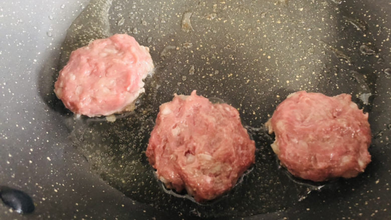 宝宝辅食,香煎肉饼,锅里放油,把肉泥摊成小饼的形状,大小和厚度要差不多。一面变色了再翻面。