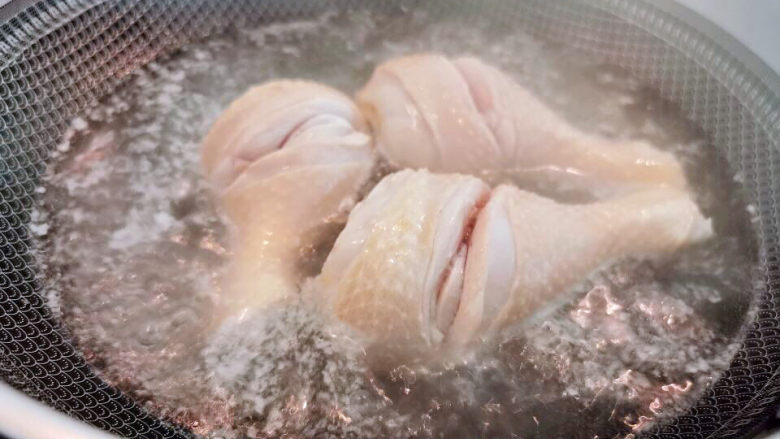 电饭锅焖鸡腿,鸡腿表面划一刀,入水汆烫至断生