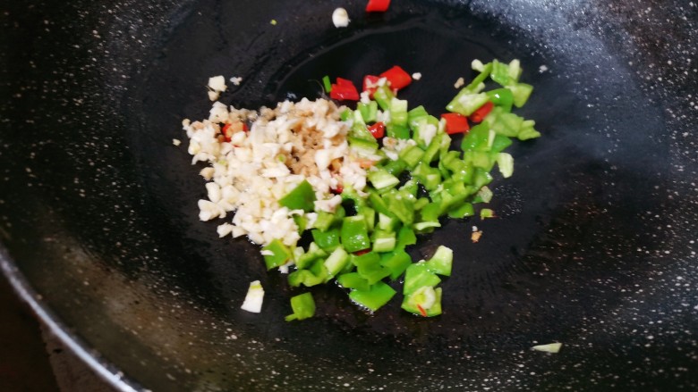尖椒皮蛋,锅里烧油,再把提前准备好的青红椒,姜蒜一起放入锅中爆香