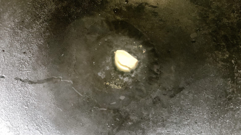 油豆腐炒青椒,热油锅,加入蒜瓣爆炒出香味