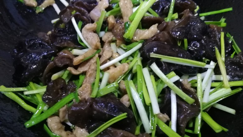 木耳炒肉丝,放入蒜苗,文火翻炒均匀。