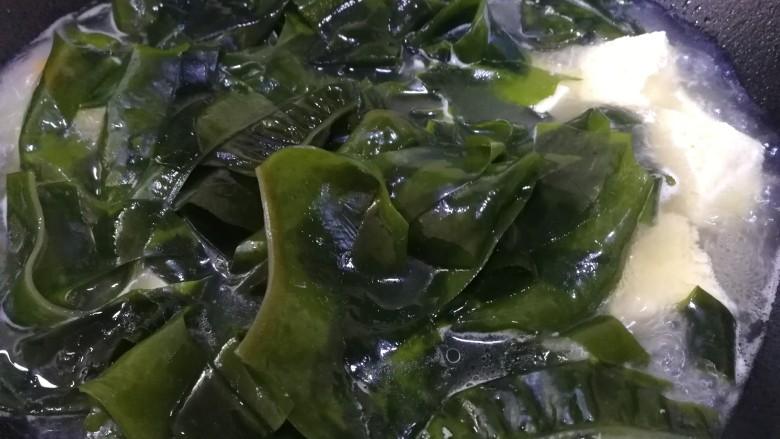 裙带菜豆腐汤,放入裙带菜,文火煮开,煮3分钟。