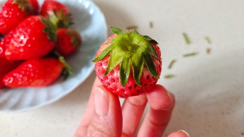 草莓糖葫芦,洗干净的草莓用厨房纸巾擦干水份,剪去小径