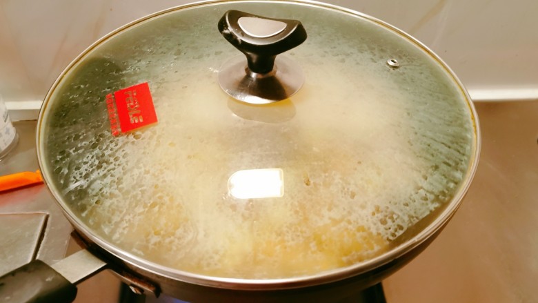 油焖春笋,添加适量清水,扣上盖子焖制,期间需要翻拌,保持受热均匀。
