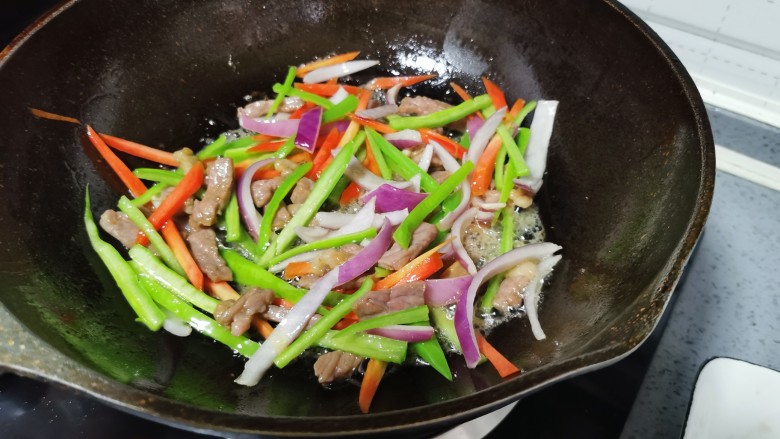 黑椒牛肉意面,放入红萝卜,青椒,洋葱翻炒均匀