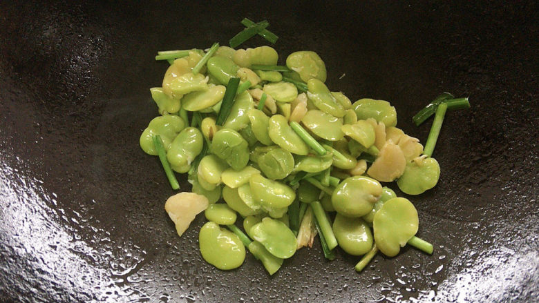 韭菜炒蚕豆,加入蚕豆仁,翻炒至变软