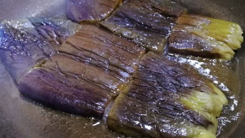 茄子盖浇饭,平底锅适量油,油热放入茄子。