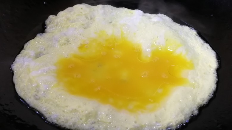 鸡蛋火腿炒饭,热锅凉油,油热倒入蛋液。