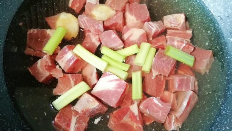 西红柿土豆炖牛肉,锅内放水,牛上脑块凉水入锅,加入一勺<a style='color:red;display:inline-block;' href='/shicai/ 718'>料酒</a>,放葱和姜一起煮开焯水。