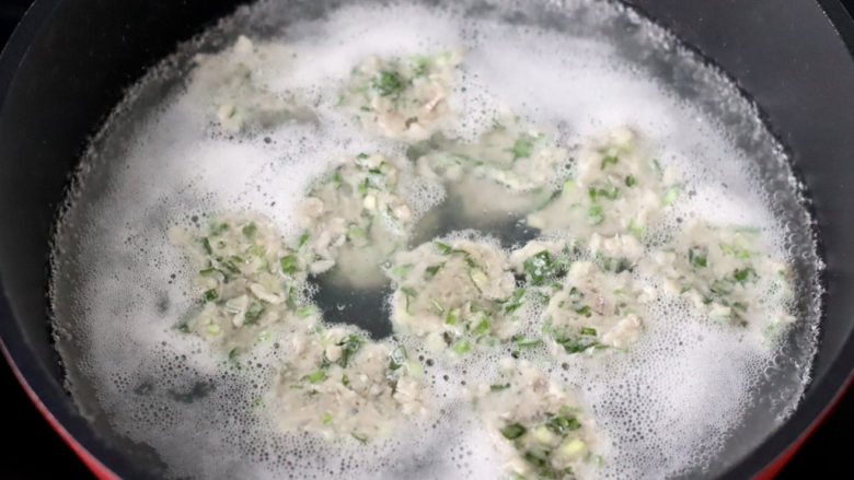 青菜鱼丸汤,锅中倒入适量的清水,用勺子把鱼馅挖成圆形放入锅中。