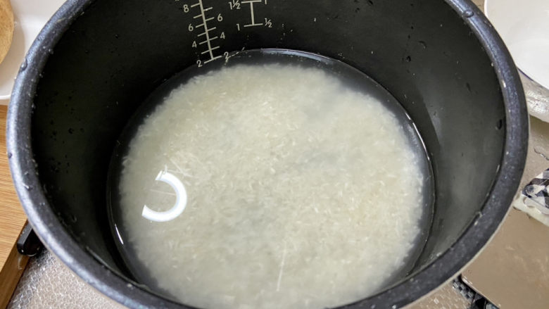 什锦香肠焖饭,大米淘洗干净,根据电饭锅标记放入适量煮米饭的清水浸泡