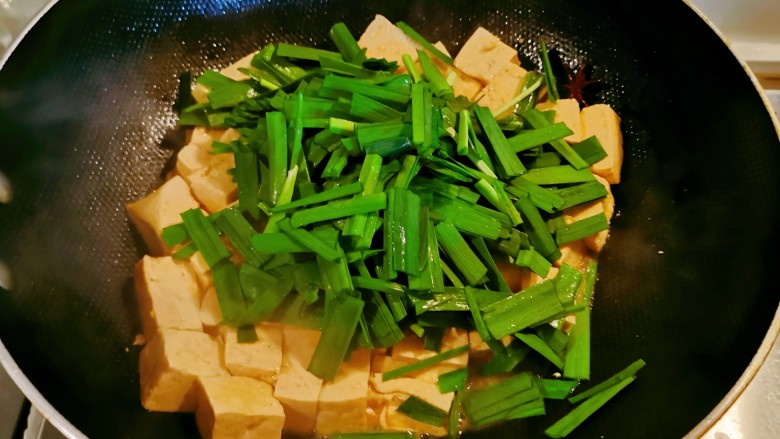韭菜豆腐,汤汁所剩无几时,放入韭菜翻炒。