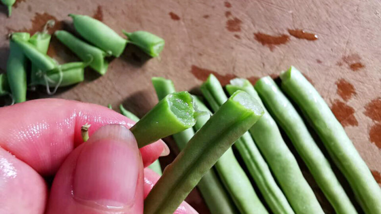 蒜泥拌豆角,豆角看上去都很有好光彩，是驴是马，溜一溜便知，豆角撕去豆荚，很短就断了，就表示很嫩