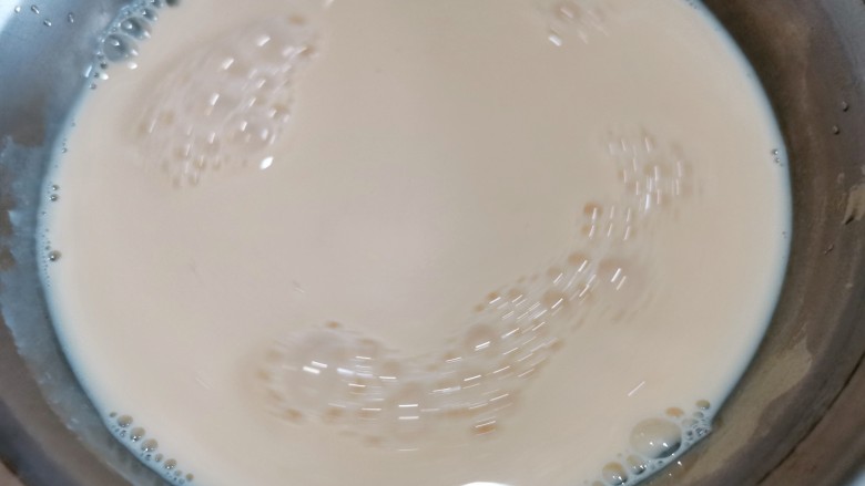 芒果双皮奶,再把煮热的牛奶用筷子挑起表面的一层皮,再把牛奶轻轻的倒入放有鸡蛋清的碗里