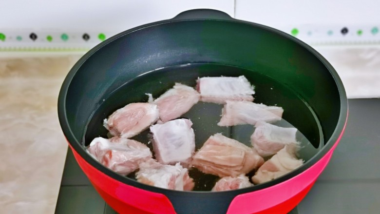 豆角焖肉,焯水:冷水下锅,大火烧开煮2-3分钟,捞出用冷水反复冲洗,淋干水分备用。
