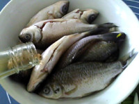 葱烤鲫鱼,将<a style='color:red;display:inline-block;' href='/shicai/ 718'>料酒</a>倒入鲫鱼,抓匀