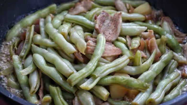 豆角焖肉,待锅内汤汁变少、豆角和土豆炖至软烂时调入适量的盐和<a style='color:red;display:inline-block;' href='/shicai/ 756'>鸡精</a>,改大火翻炒收汁即可,汤汁不必收的太干。