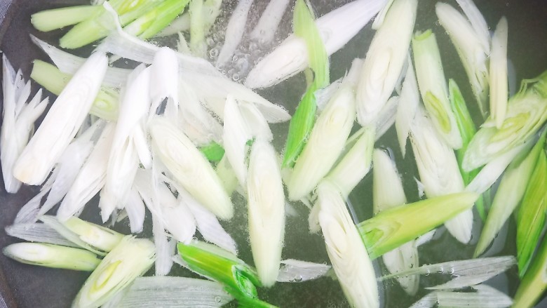 凉拌蒜苗,锅中烧开水,加入蒜苗焯水30秒。