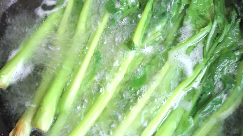 蒜蓉菜心,水开后焯熟菜心。再淋入冷水,待水控干。
