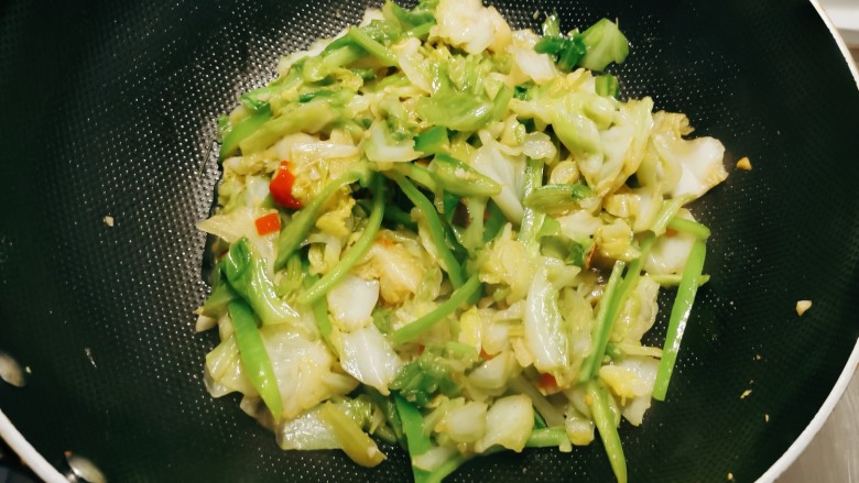 双椒手撕包菜,翻炒均匀,青椒丝断生。
