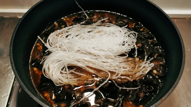 木耳炒粉丝,放入200克清水烧开,放入泡好的粉丝。