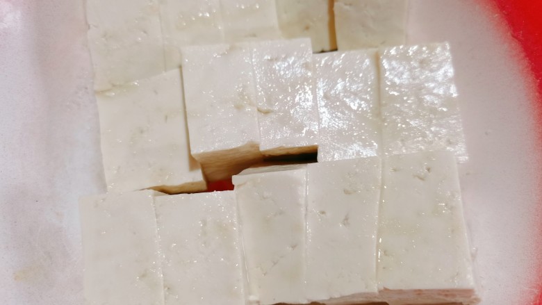 豆腐蛋花汤,再把它切成小块,再用开水烫一下,把水倒掉,再加入少许食用盐,把它腌制一会,这样做出来的豆腐入味一点,也没有涩味