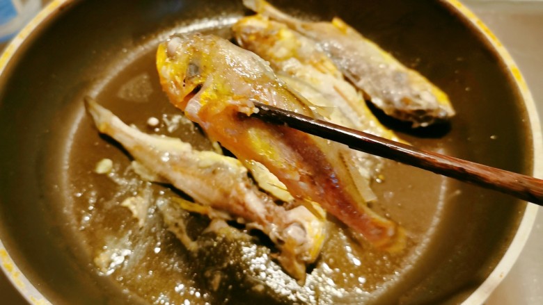 茄汁黄鱼,一面定型后翻另一面煎,煎至两面金黄出锅,码放鱼盘中。