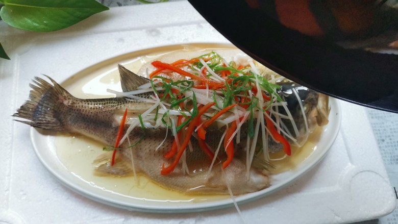 油泼鱼,锅里烧热油,对着葱丝红椒丝泼几下