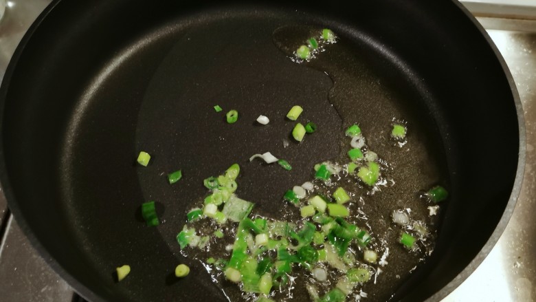 西红柿炒土豆丝,起油锅放入食用油,油热后放入葱白部分炝锅。